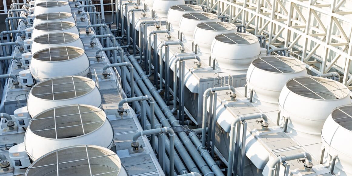 A large white tanks with pipes.