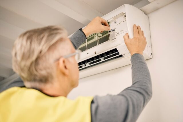 maintenance-installation-and-back-of-a-man-with-a-2023-02-24-23-58-15-utc (1)-min man repairing ac