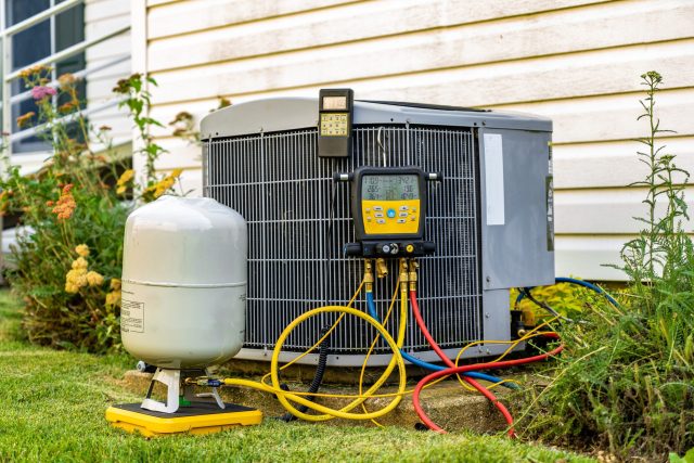An,Old,Air,Conditioning,Unit,That,Is,Being,Repaired,By