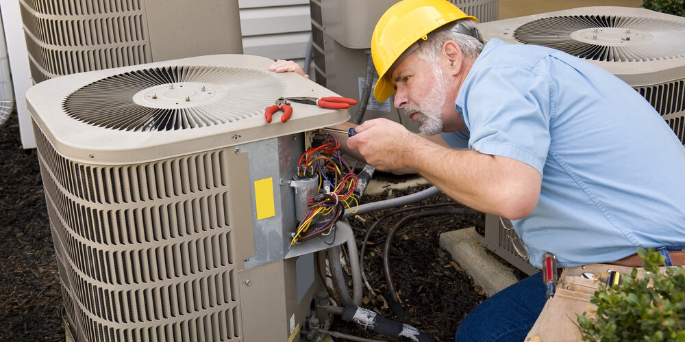 man fixing AC Residential air conditioning venice fl