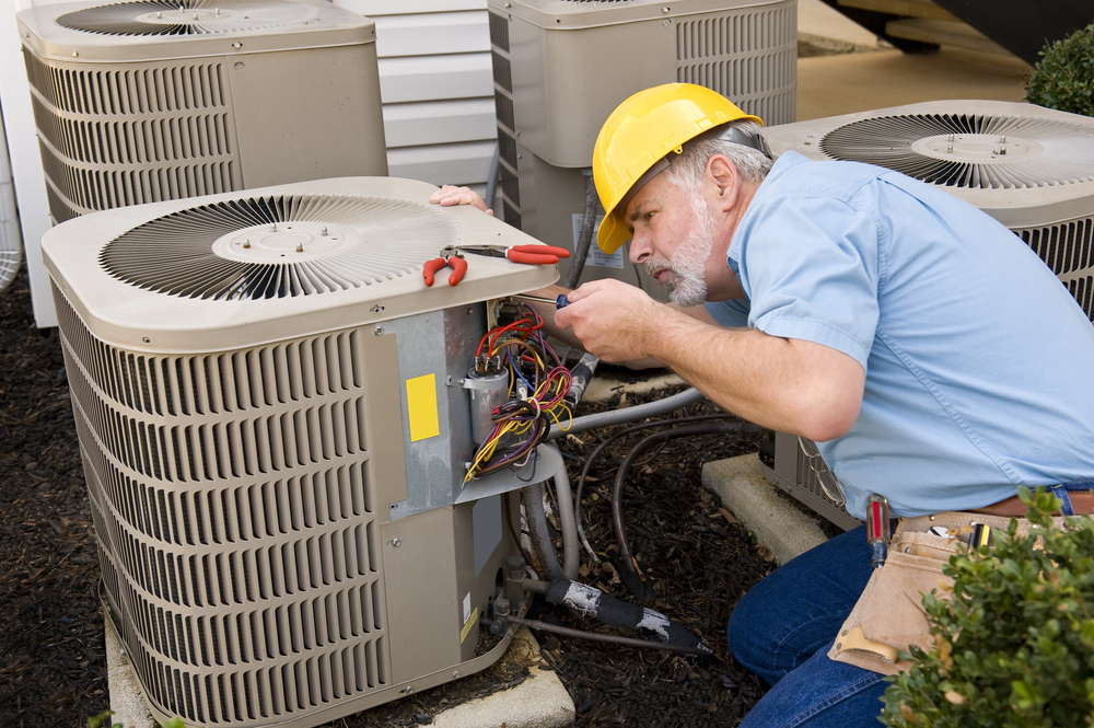 man fixing AC Residential air conditioning venice fl