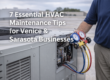 HVAC technician servicing a rooftop commercial air conditioning unit in Venice and Sarasota, Florida, using professional gauges to perform routine HVAC maintenance that helps local businesses improve efficiency and prevent system downtime.