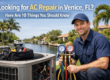 A technician kneels next to AC repair equipment by a canal with palm trees, holding HVAC gauges. Text reads: "Looking for AC Repair in Venice, FL? Here Are 10 Things You Should Know.